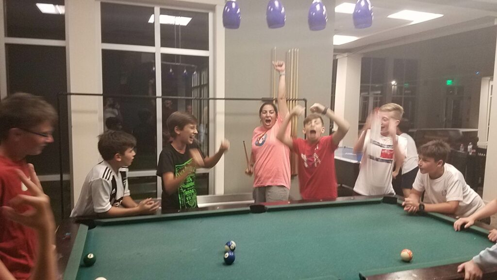 boys-and-girls-cheering-while-playing-pool